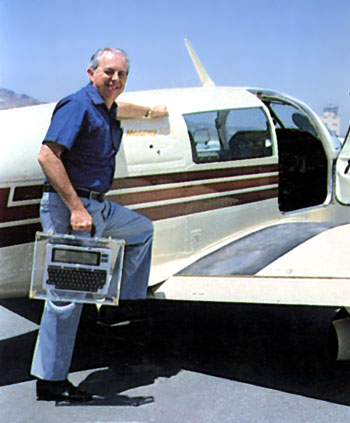 Dr. Lien stepping onto the wing of his Mooney with Model 100 in hand