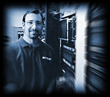 Portrait of Morgan Davis in 2002 standing near telco racks